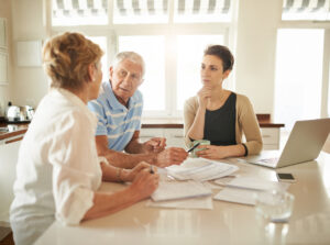 Shot of a senior couple getting advice from their financial consultant in their kitchen